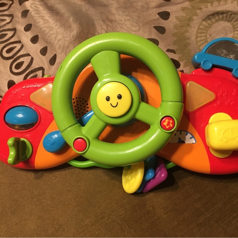 Interactive steering wheel toy